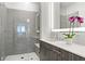 Modern bathroom with double vanity, walk-in shower, and gray tile at 775 Juniper Ne St # 413, Atlanta, GA 30308