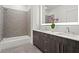 Bathroom with double vanity, bathtub, and gray tile at 775 Juniper Ne St # 413, Atlanta, GA 30308