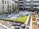 Modern apartment courtyard with snow-covered lawn, seating areas, and landscaping at 775 Juniper Ne St # 413, Atlanta, GA 30308