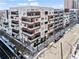 Modern apartment building with balconies and street-level entrance; light dusting of snow on the ground at 775 Juniper Ne St # 413, Atlanta, GA 30308