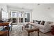 Spacious living area featuring a plush sofa and large windows at 775 Juniper Ne St # 413, Atlanta, GA 30308