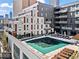 Rooftop pool with a teal cover and lounge chairs; partially covered in snow at 775 Juniper Ne St # 413, Atlanta, GA 30308