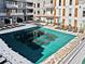 Rooftop pool with a teal cover, surrounded by lounge chairs and covered in a light layer of snow at 775 Juniper Ne St # 413, Atlanta, GA 30308