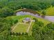 Aerial view of a home on a large lot near a pond at 833 Hines Rd, Moreland, GA 30259