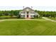 Stunning aerial view of a grand home with a pool and expansive lawn at 833 Hines Rd, Moreland, GA 30259
