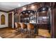 Custom-built basement bar with leather stools and granite countertop at 833 Hines Rd, Moreland, GA 30259