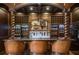 Basement bar with detailed woodwork and wine storage at 833 Hines Rd, Moreland, GA 30259