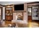 Brick fireplace with a large mantel in a finished basement at 833 Hines Rd, Moreland, GA 30259
