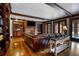 Basement rec room with leather sectional, built-ins, and fireplace at 833 Hines Rd, Moreland, GA 30259