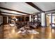 Spacious basement recreation room with leather sectional sofa, built-in shelving, and hardwood floors at 833 Hines Rd, Moreland, GA 30259