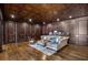 Cozy basement sitting area with hardwood floors and wood paneling at 833 Hines Rd, Moreland, GA 30259