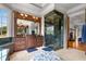 Bathroom with marble shower, vanity, and hardwood floors at 833 Hines Rd, Moreland, GA 30259