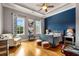 Bedroom with hardwood floors, blue accent wall, and ample natural light at 833 Hines Rd, Moreland, GA 30259
