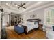Luxurious main bedroom with hardwood floors, high ceilings, and seating area at 833 Hines Rd, Moreland, GA 30259