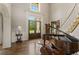 Grand entry with hardwood floors, a piano, and a curved staircase at 833 Hines Rd, Moreland, GA 30259