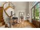 Elegant entry featuring hardwood floors, a staircase, and views to dining room at 833 Hines Rd, Moreland, GA 30259