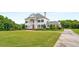 Elegant two-story home with columns and manicured lawn at 833 Hines Rd, Moreland, GA 30259