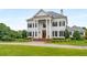 Stunning white home with black shutters and a long driveway at 833 Hines Rd, Moreland, GA 30259