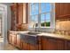 Gourmet kitchen features granite counters, copper sink, and custom cabinetry at 833 Hines Rd, Moreland, GA 30259