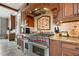 High-end stainless steel appliances and custom wood cabinetry in kitchen at 833 Hines Rd, Moreland, GA 30259