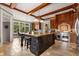 Gourmet kitchen with large island, stainless steel appliances, and wood cabinetry at 833 Hines Rd, Moreland, GA 30259