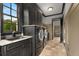 Laundry room with granite countertop, dark cabinets, and a utility sink at 833 Hines Rd, Moreland, GA 30259