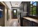 Bright laundry room, features granite countertops, dark cabinetry, and high-end washer and dryer at 833 Hines Rd, Moreland, GA 30259