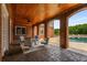 Covered patio with seating area, brick columns, and wooden ceiling at 833 Hines Rd, Moreland, GA 30259