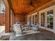 Relaxing covered patio with seating and pool views at 833 Hines Rd, Moreland, GA 30259