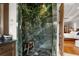 Large walk-in shower with marble walls and bench at 833 Hines Rd, Moreland, GA 30259