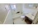 Bathroom with white tile, a tub, and needs some updates at 1156 Sw Hubbard Sw St, Atlanta, GA 30310