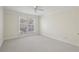 Well-lit bedroom with large window, ceiling fan, and neutral colored carpet at 1634 Ponce De Leon Ne Ave # 514, Atlanta, GA 30307