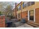 Townhome featuring brick and siding, black shutters, and neatly landscaped front entrance with black door at 1634 Ponce De Leon Ne Ave # 514, Atlanta, GA 30307