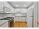 Bright eat-in kitchen with white cabinets, stainless steel appliances, and wood flooring at 1634 Ponce De Leon Ne Ave # 514, Atlanta, GA 30307