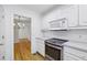 Bright kitchen with white cabinets, stainless steel appliances, and a view into the dining room at 1634 Ponce De Leon Ne Ave # 514, Atlanta, GA 30307