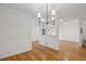 Bright living room featuring modern lighting and wainscoting with an open floorplan to other rooms at 1634 Ponce De Leon Ne Ave # 514, Atlanta, GA 30307