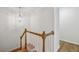 Bright staircase featuring hardwood steps and handrail, white spindles, and decorative light fixture at 1634 Ponce De Leon Ne Ave # 514, Atlanta, GA 30307