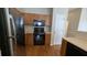 Modern kitchen with stainless steel appliances and wood cabinets at 909 Milton Cir, Loganville, GA 30052