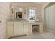 Spa-like bathroom featuring a marble vanity, patterned floors, and a window at 106 Peachtree Battle Nw Ave, Atlanta, GA 30305