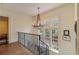 Upper hallway with chandelier, hardwood floors, and wrought iron railing at 106 Peachtree Battle Nw Ave, Atlanta, GA 30305