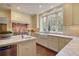 Kitchen boasts marble island, farmhouse sink, and custom cabinetry at 106 Peachtree Battle Nw Ave, Atlanta, GA 30305