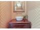 Charming powder room with a unique vessel sink and patterned wallpaper at 106 Peachtree Battle Nw Ave, Atlanta, GA 30305