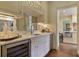 Wet bar with marble countertop, wine cooler, and mirrored backsplash at 106 Peachtree Battle Nw Ave, Atlanta, GA 30305