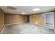 Unfinished basement area with wood paneling and concrete floors at 3246 E 5 E Hwy, Carrollton, GA 30116