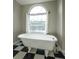 Bathroom with clawfoot tub and checkerboard floor at 3246 E 5 E Hwy, Carrollton, GA 30116