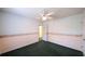 Bright bedroom featuring green carpet, ceiling fan and decorative border at 3246 E 5 E Hwy, Carrollton, GA 30116