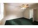 Well-lit bedroom, green carpet, ceiling fan and access to a closet at 3246 E 5 E Hwy, Carrollton, GA 30116