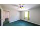 Spacious bedroom with green carpet, ceiling fan, and ample closet space at 3246 E 5 E Hwy, Carrollton, GA 30116