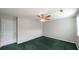 Spacious bedroom with green carpet, ceiling fan and closet at 3246 E 5 E Hwy, Carrollton, GA 30116