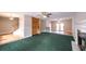 Large living area with fireplace, green carpet, and stairs at 3246 E 5 E Hwy, Carrollton, GA 30116